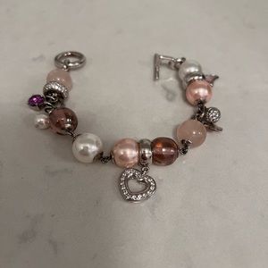 Bracelet with charms. Shades of pink and silver.